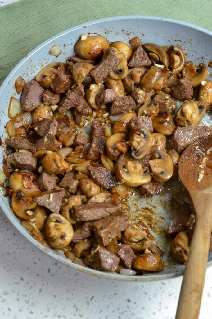 Skillet browned beef with browned mushrooms and caramelized onions. 