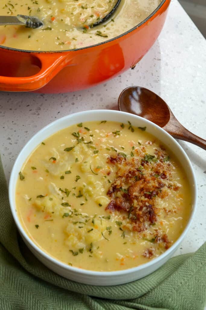 A scrumptious soup filled with cauliflower, onions, carrots, and celery in a creamy cheesy broth and topped with bacon and buttery bread crumbs. 