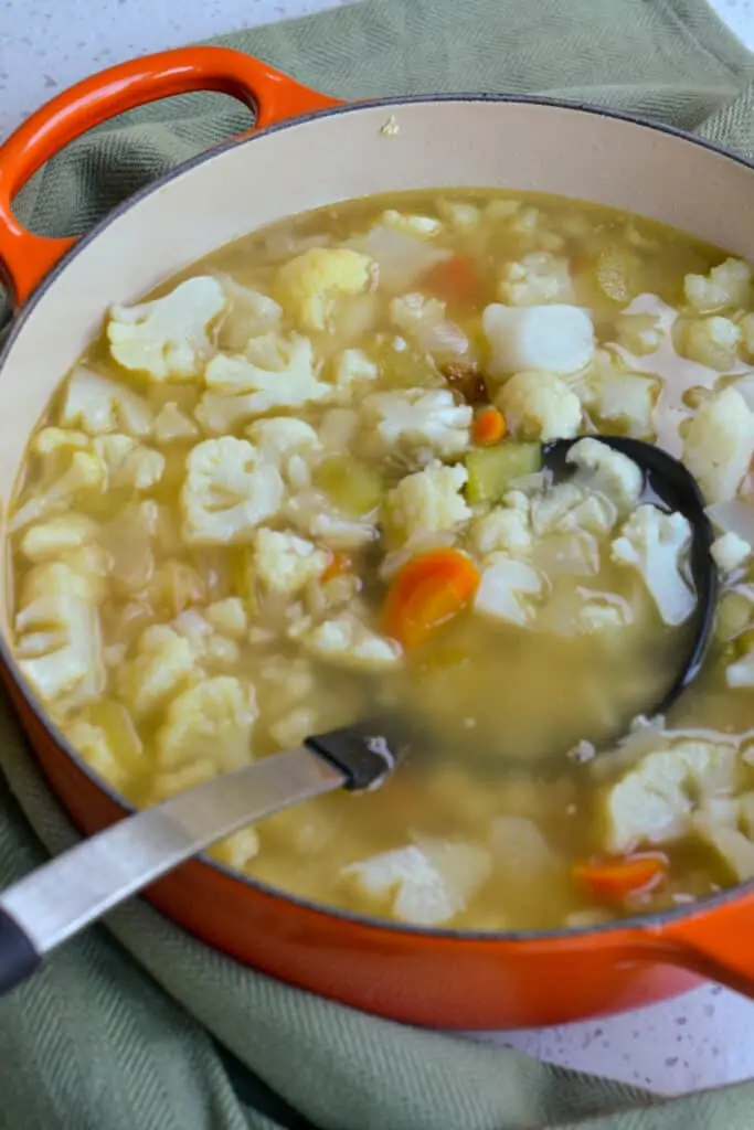 Simmer the cauliflower in chicken broth until fork tender.  