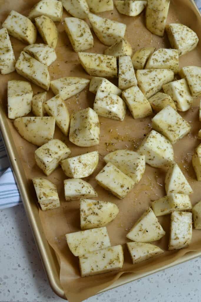 Arrange the seasoned turnip cubes on a baking sheet covered with parchment paper. 