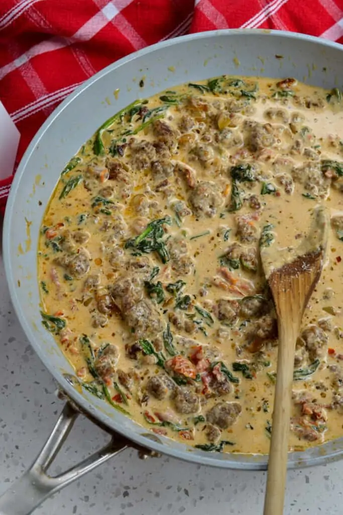 Add the cooked sausage to the sauce before adding the pasta. 