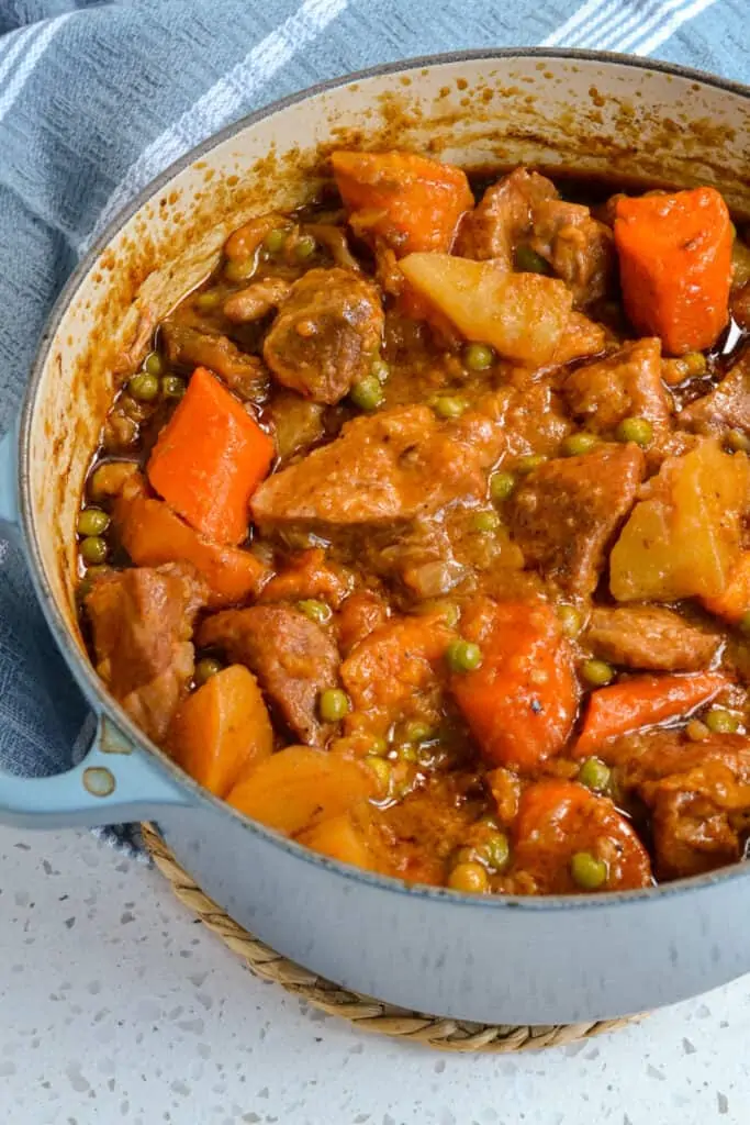 A tasty pork stew made with onions, garlic, carrots, potatoes, sweet potatoes, peas, and pork butt or pork shoulder, all in a perfectly seasoned tomato beef base. 