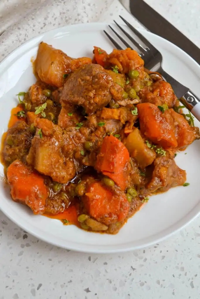 An easy family favorite Pork Stew Recipe with onions, garlic, and a medley of root vegetables all in a beefy tomato base.  Fix this tasty heaty homecooked meal today. 