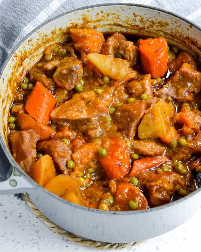 A Dutch oven full of pork stew.