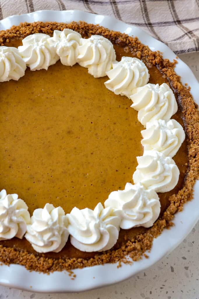 A homemade pumpkin pie recipe with fresh whipped cream. 