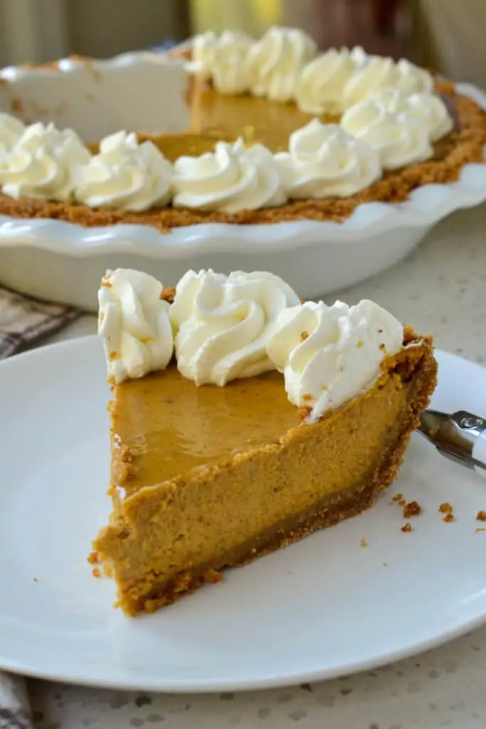 This made from scratch Pumpkin Pie recipe starts with a three-ingredient graham cracker pie crust followed by a five-minute creamy pumpkin custard with the perfect blend of spices all topped with homemade whipped cream. 