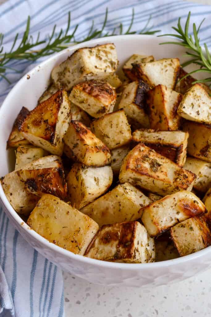 A bowl of Roasted Turnips with herbs and seasonings. 