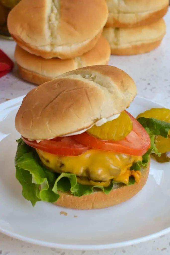 An air fryer hamburger with lettuce. tomato, and pickle. 