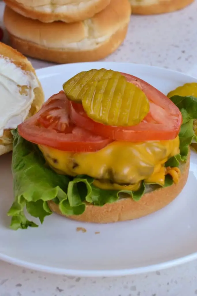 If cheeseburgers are desired, add a slice of cheese to the top of each burger and close the door to the air fryer.  The residual heat will melt the cheese.  