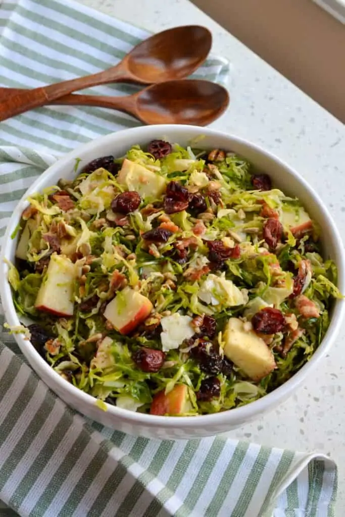 A delicious and easy Brussels Sprout Salad loaded with texture and crunch from crisp apples, dried cranberries, sweet pecans, and freshly grated Parmesan Cheese. All tossed with a mouthwatering good honey mustard vinaigrette with a touch of citrus. 