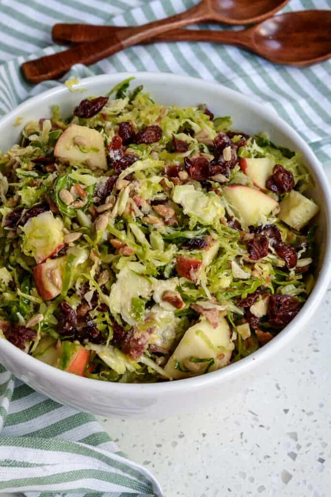 A bowl full of shaved brussels sprout salad. 
