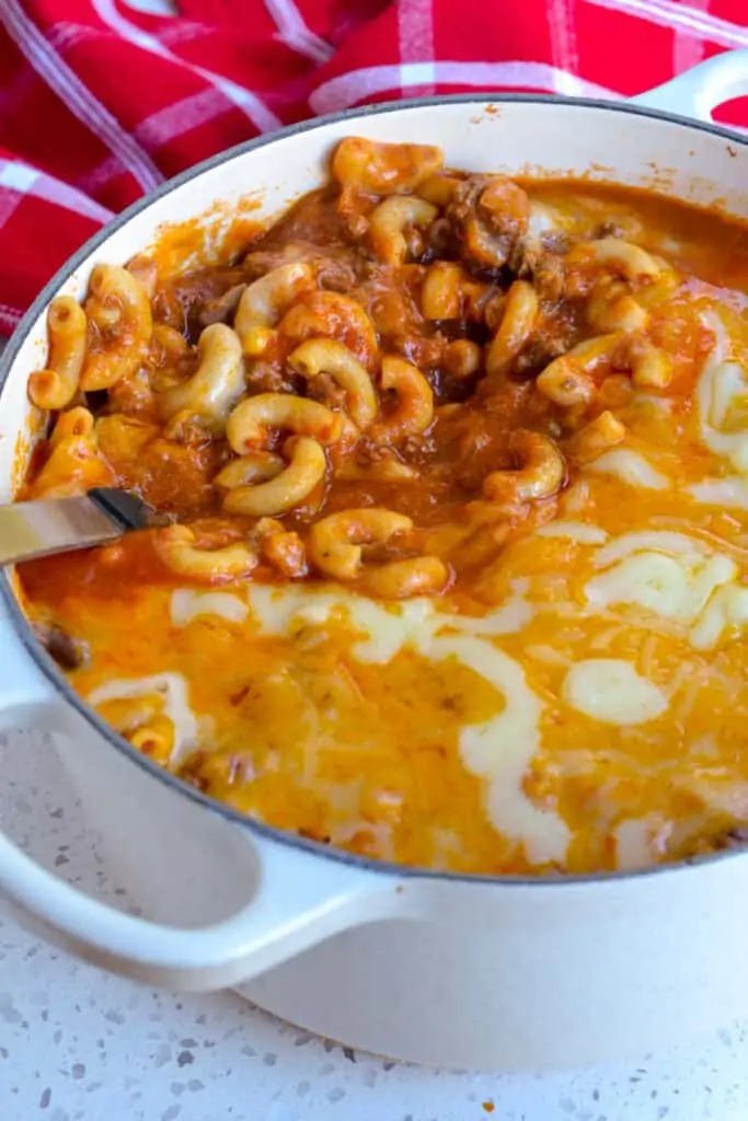 An easy delectable one-pot Chili Mac made with ground beef, elbow macaroni, crushed tomatoes, and a perfect blend of spices, all covered with oodles of cheddar and Monterey Jack cheese. 