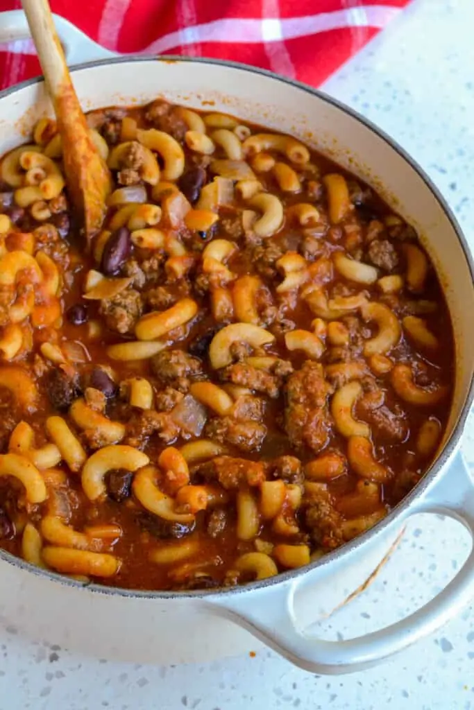 Next, stir in the crushed tomatoes, tomato sauce, kidney beans, beef broth, chili powder, ground cumin, and cayenne pepper. Bring to a low boil over medium-high heat and stir in the elbow macaroni.  Reduce to a simmer and cook until the noodles are tender.