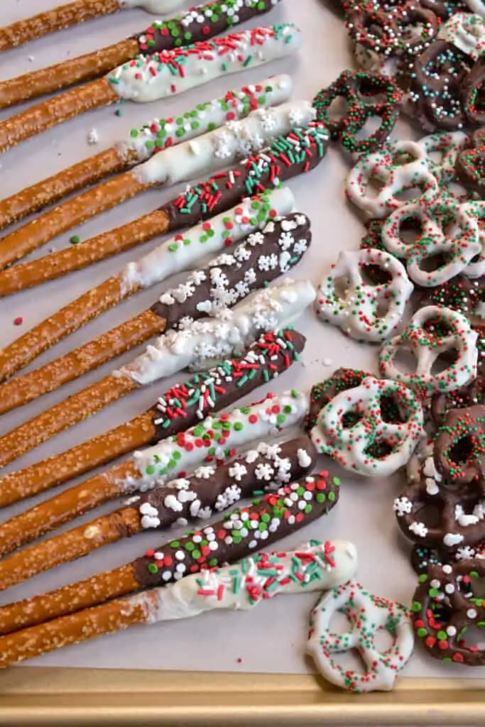 Chocolate Covered Pretzel twists and rods on a cookie sheet covered with parchment paper.