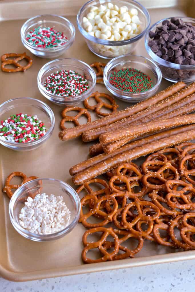To make chocolate covered pretzels you will need chocolate chips, pretzel twists, shortening, pretzel rods, sprinkles, nuts and coconut. 