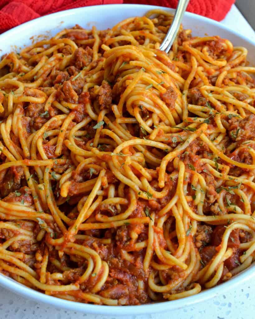 A close up view of Instant Pot Spaghetti in a big white bowl.
