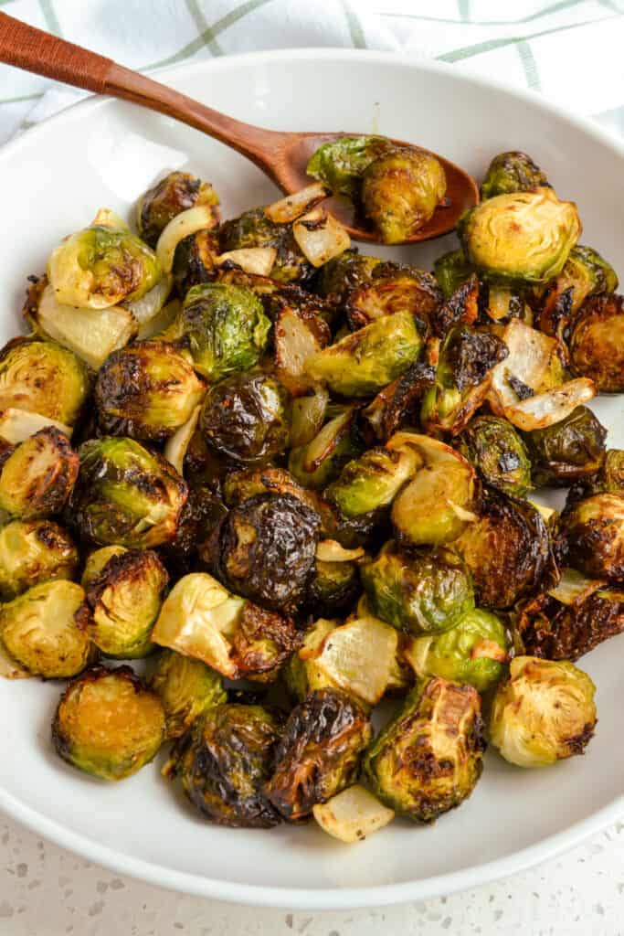 A bowl full of brussels sprouts cooked up tender and crispy in the air fryer