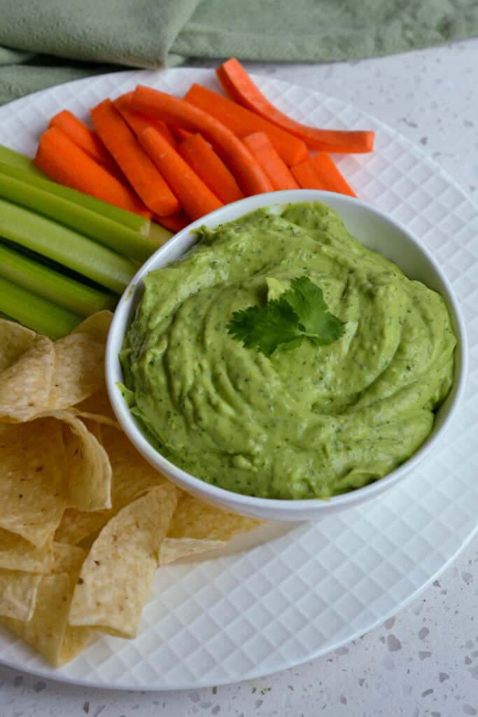 A tasty Avocado Dip or spread made quickly and easily in the food processor in less than ten minutes. Enjoy it with fresh tortilla chips, carrot sticks, celery sticks, cucumbers, radishes, and bagel chips.