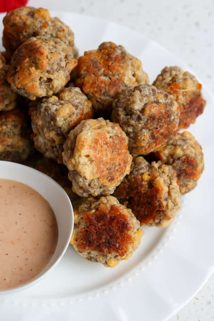 A plate full of Sausage Balls with Comeback Sauce