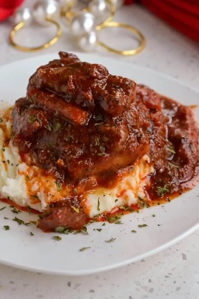 This Swiss Steak Recipe combines melt in your mouth tenderized round steak braised with onions, carrots, garlic, and tomatoes.  For a complete meal serve over creamy mashed potatoes, white rice, or Amish egg noodles.  