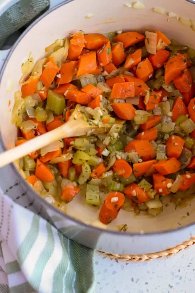 Start by cooking the onions and celery until they are soft. 