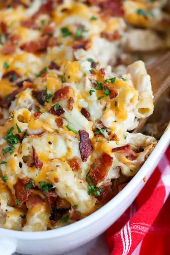 A scrumptious Chicken Bacon Ranch Casserole with browned chicken pieces, crispy bacon, and rigatoni all in a ranch seasoned alfredo sauce and topped with mozzarella and cheddar cheeses.  
