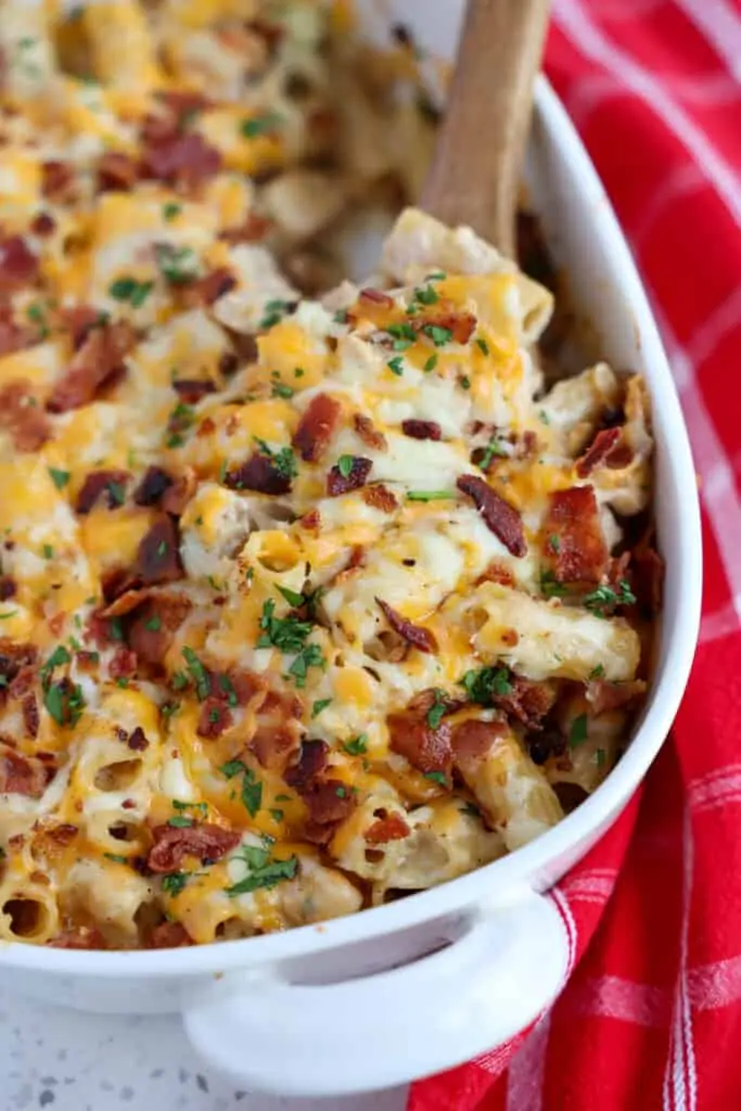 This Chicken Bacon Ranch Casserole is loaded with golden brown chicken pieces, crisp smoked bacon, alfredo sauce, ranch seasoning, pasta, and a generous helping of mozzarella and cheddar cheese.