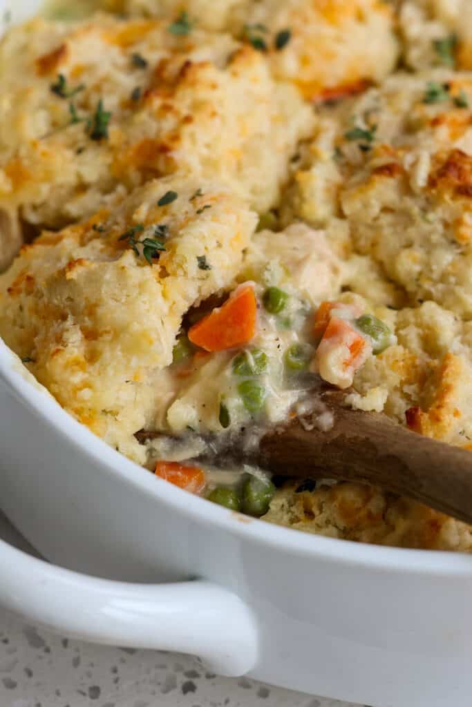 Chicken and Biscuit Casserole with onions, peas, and carrots. 