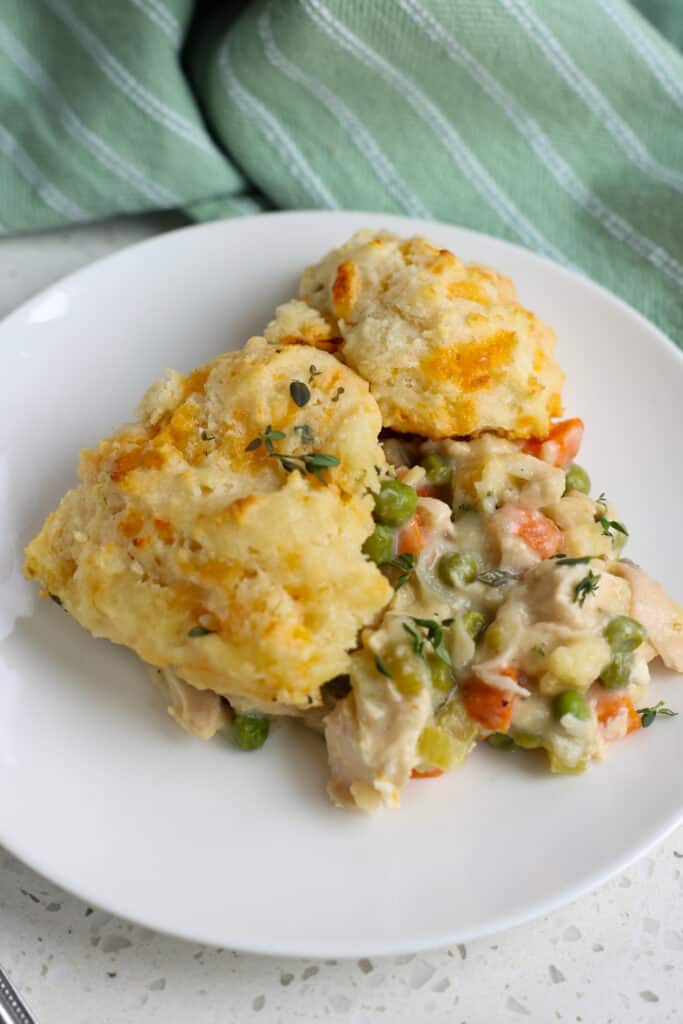 A plate full of roasted chicken and biscuit casserole. 
