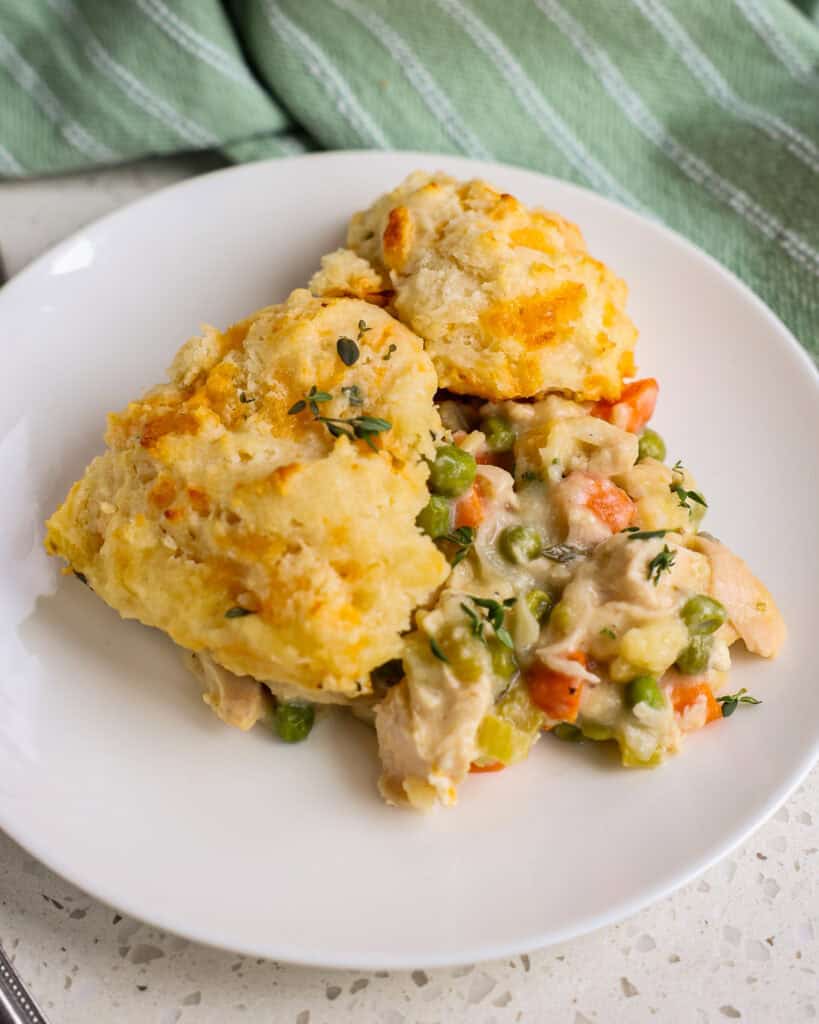 Chicken and Biscuits ready to be served on a white plate.