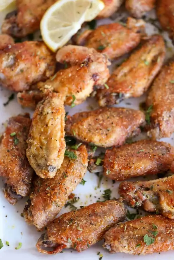 A platter full of lemon pepper chicken wings. 