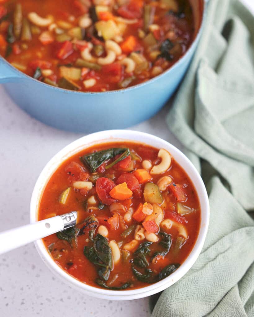 An overhead view of a bowl full of minestrone soup.