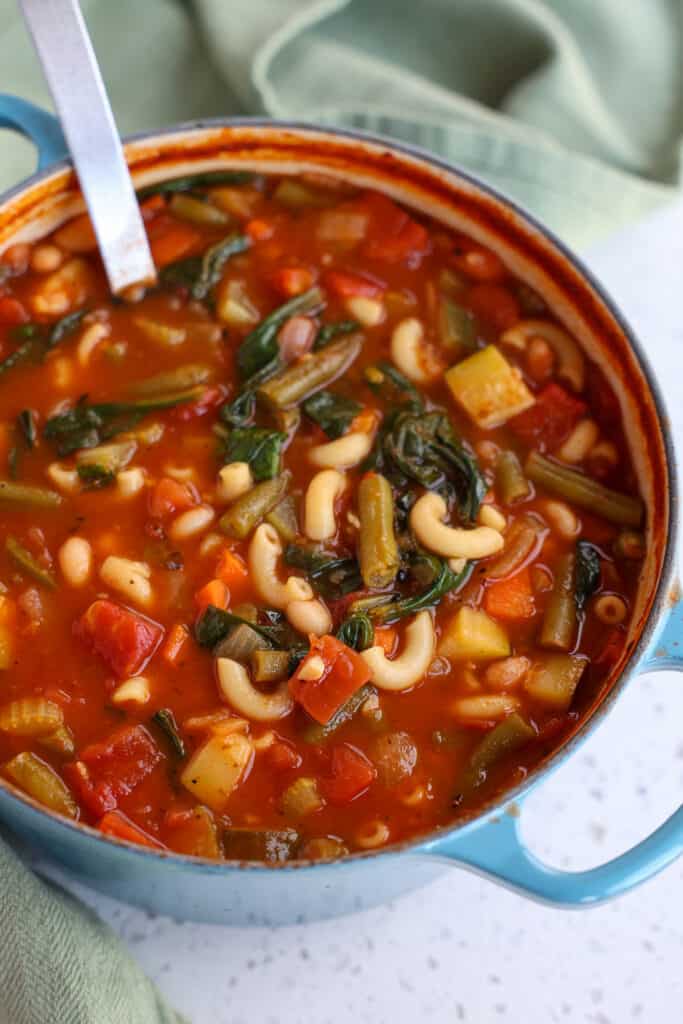 Minestrone is a heartier thick Italian version of vegetable soup with beans and pasta.   
