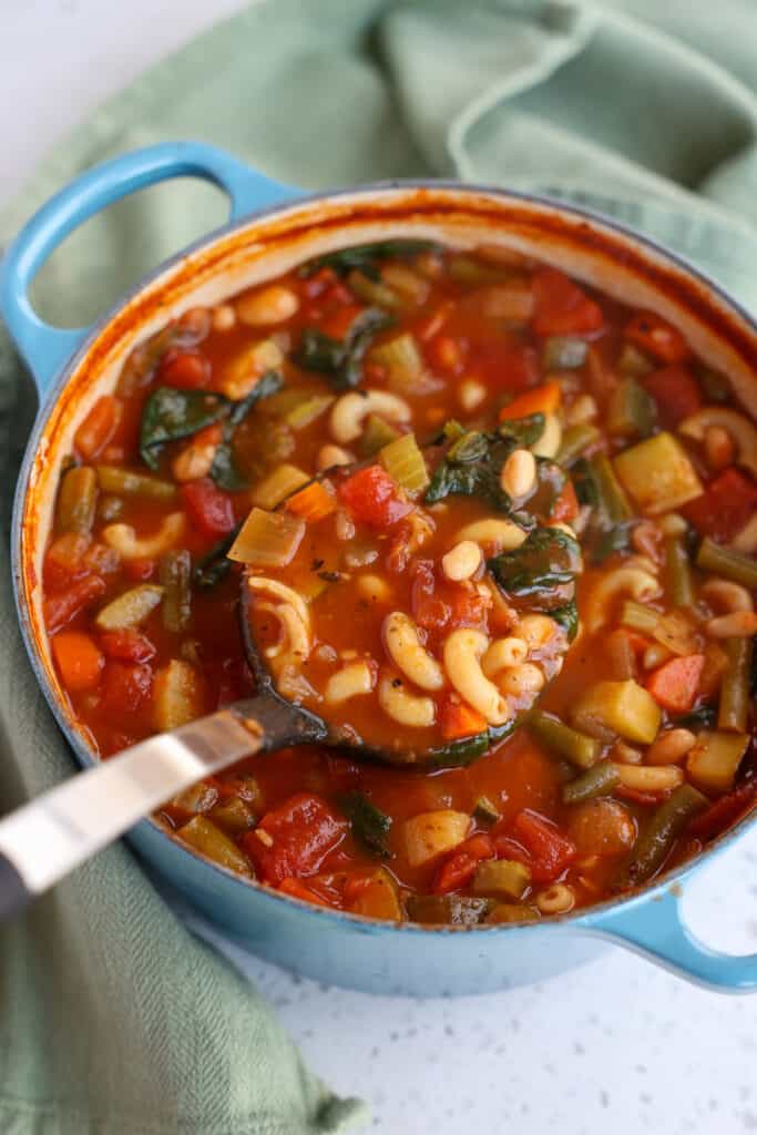 A classic Italian Minestrone Soup Recipe loaded with fresh vegetables like onions, carrots, celery, tomatoes, zucchini, and green beans in a seasoned tomato-based broth with beans and pasta. 
