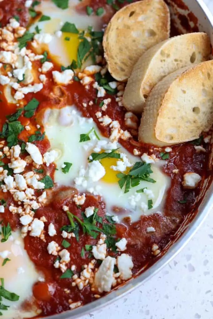 Eggs poached in tomato sauce sprinkled with feta cheese and parsley. 