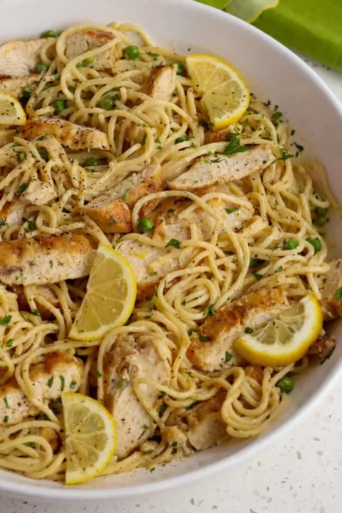 Toss the spaghetti with the chicken and add fresh lemon slices and chopped parsley.  
