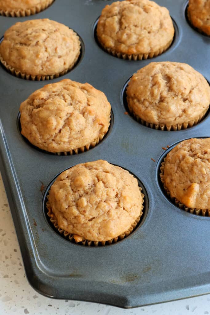 Warm homemade applesauce muffins in a tin. 