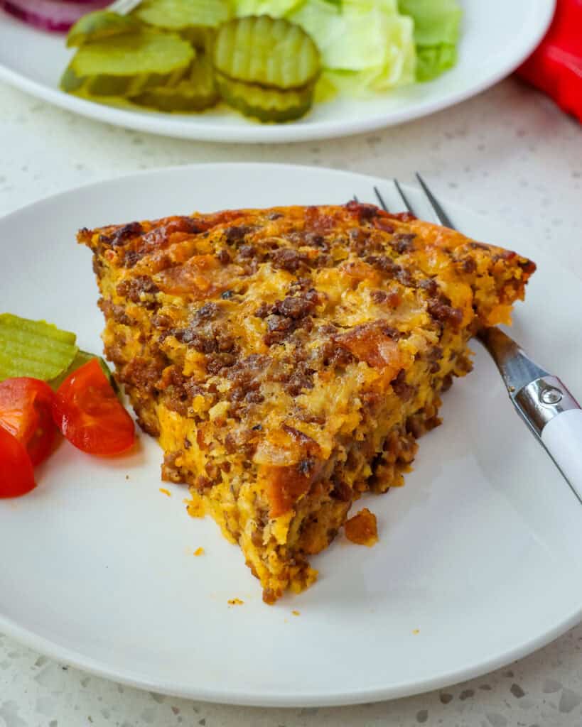 Delicious and easy Cheeseburger Pie made with ground beef, bacon, onions, cheddar, Pepper Jack Cheese, and Bisquick Baking Mix. 