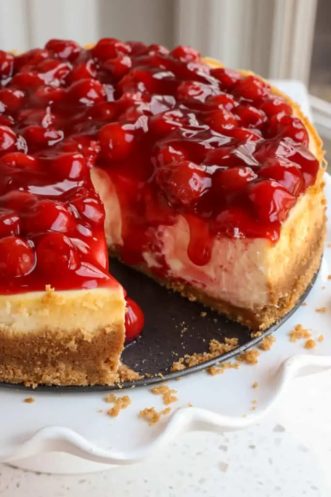 Cherry cheesecake with a slice removed. 
