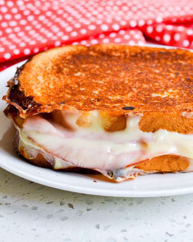 The side view of a grilled egg, ham, and cheese sandwich. 