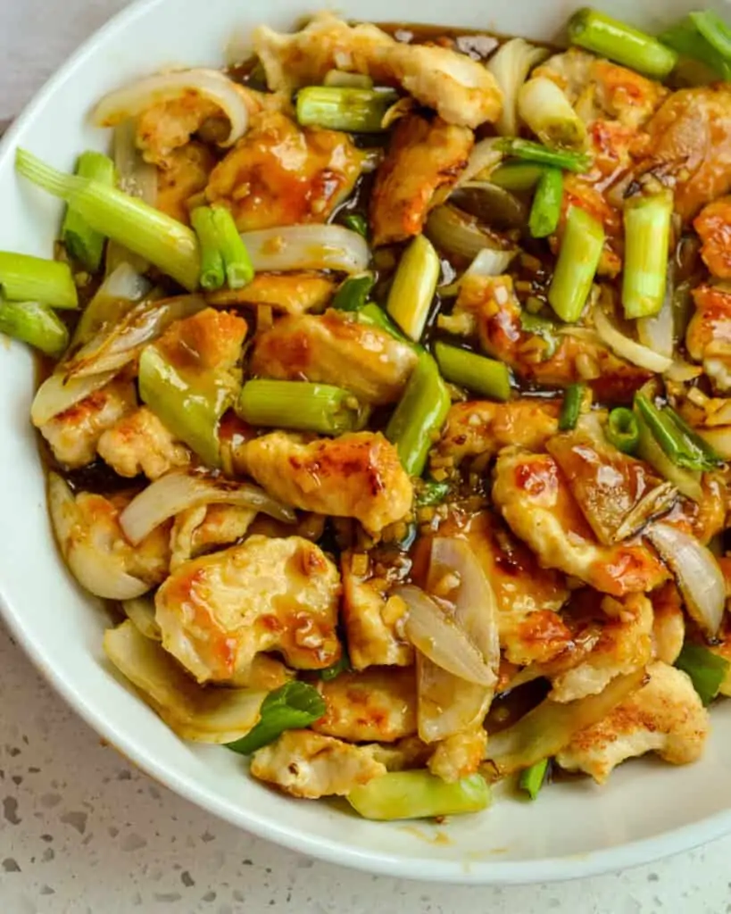 This Mongolian Chicken Recipe combines crispy stir-fried chicken, onions, and scallions in an easy-to-make sweet and salty garlic ginger sauce. 