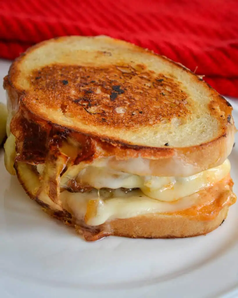 A grilled patty melt on a single serving plate. 