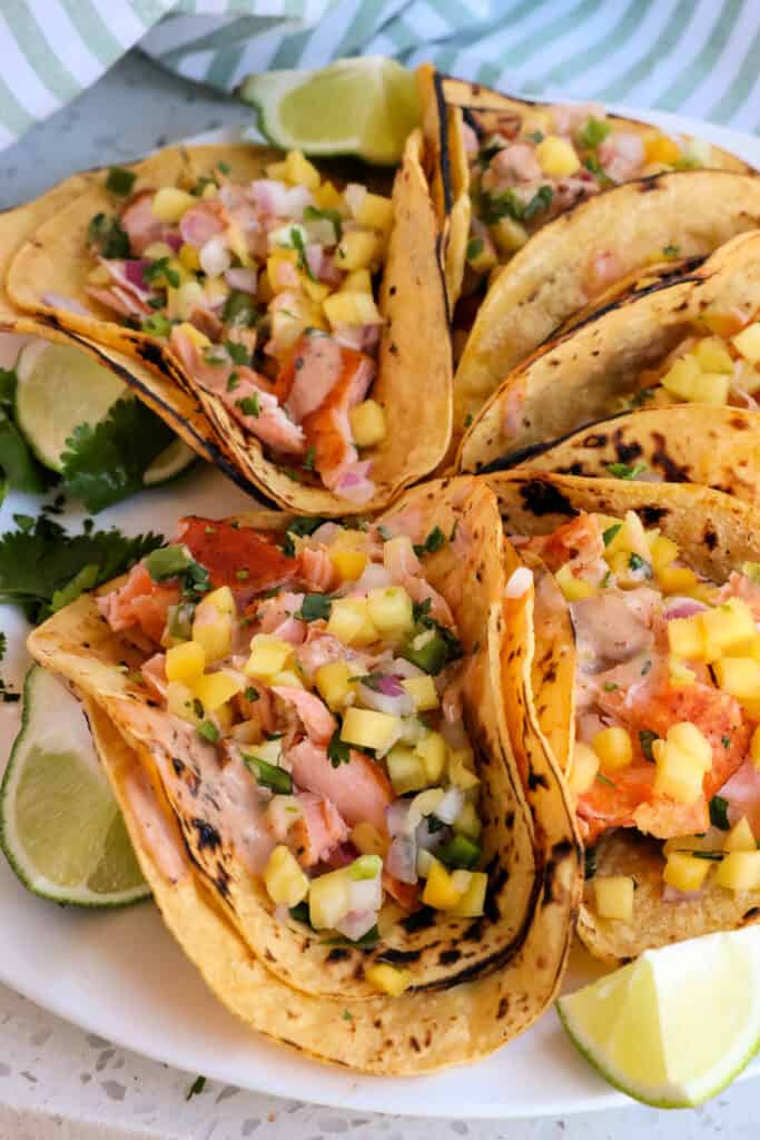 Layer the corn tortillas with the pan seared salmon, mango salsa, and chipotle ranch. 