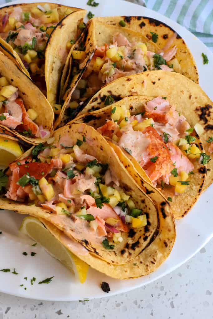 Serve the salmon tacos promptly so the corn tortillas do not become soggy. 