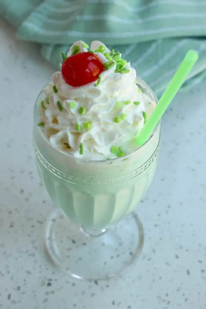 An Irish Shamrock shake with whipped cream and a cherry. 