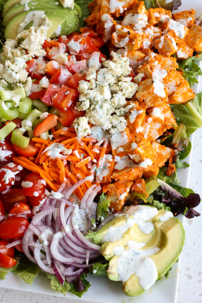 A tasty Buffalo Chicken salad with grilled buffalo chicken and homemade ranch dressing. 