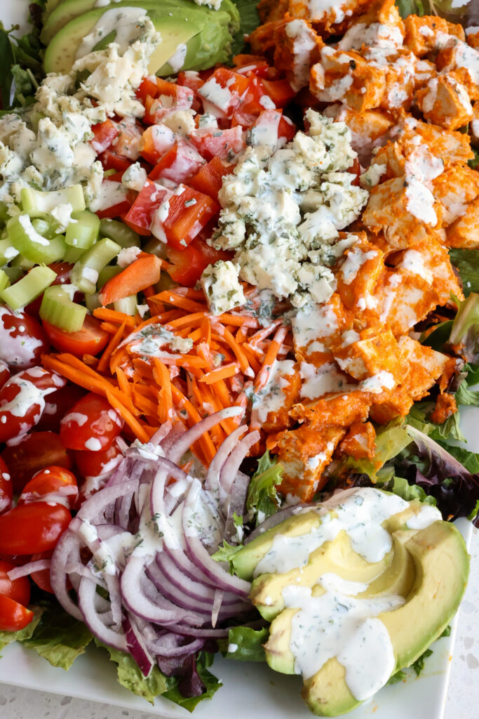 A mouth watering delicious Buffalo Chicken salad made with grilled Buffalo Chicken, homemade ranch dressing, romaine lettuce, carrots, celery, and bleu cheese