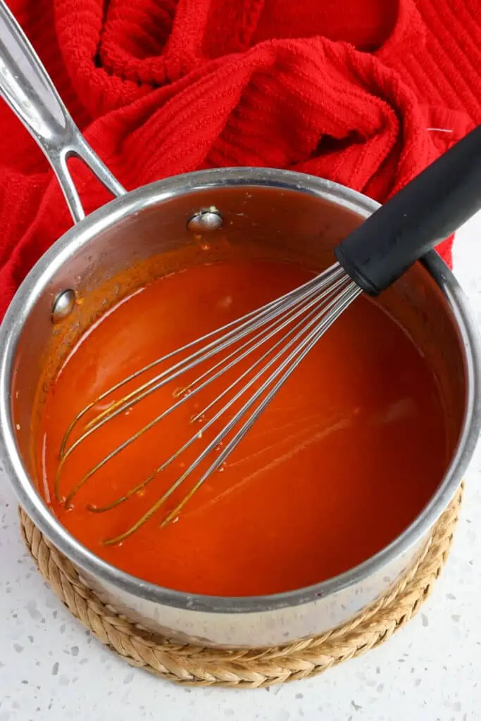 Heat the ingredients for the Buffalo Sauce up in a saucepan. 