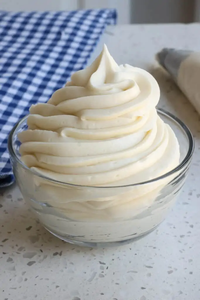 A small bowl full of pipeable cream cheese frosting.