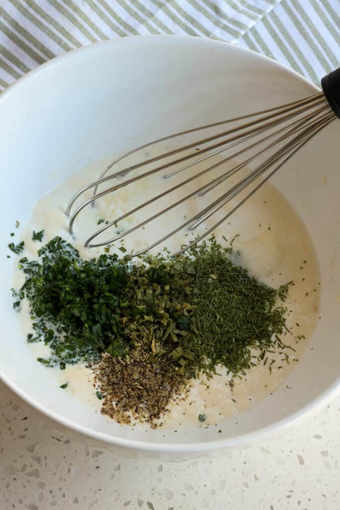 The ingredients for ranch dressing in a mixing bowl.  